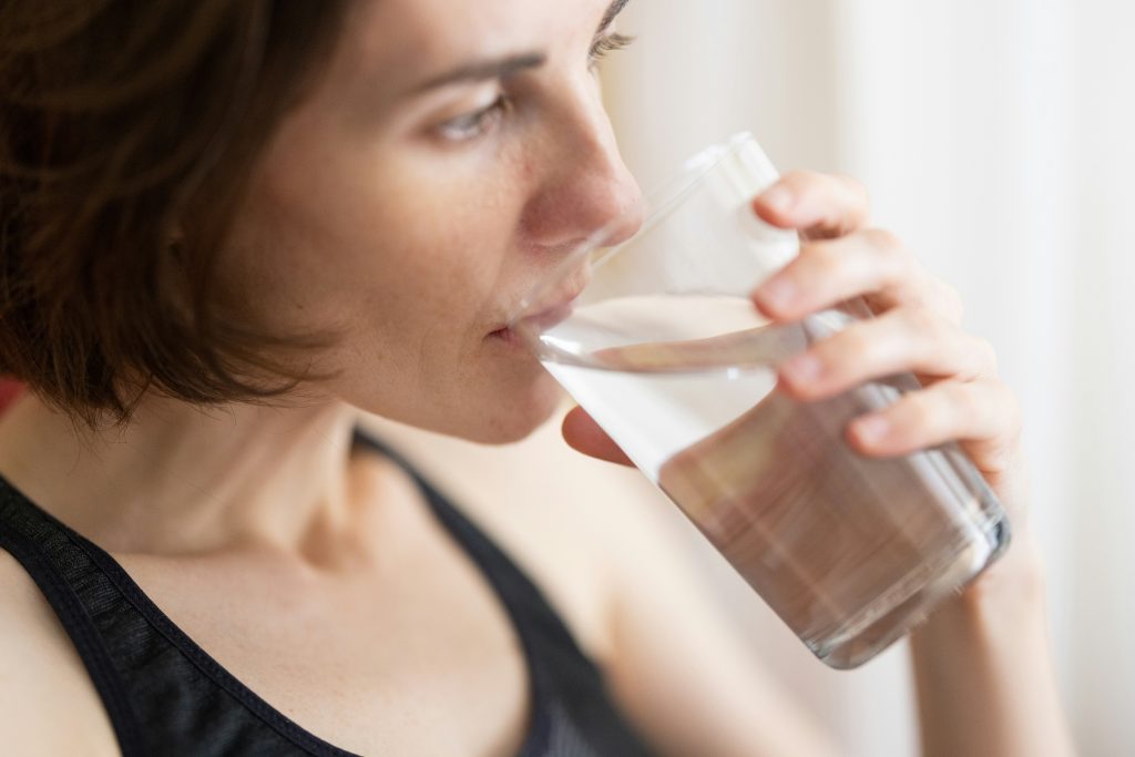 thirsty woman drinking a glass of water
