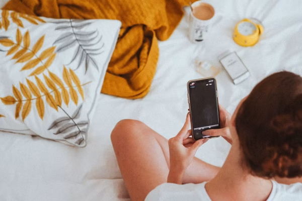 woman checking phone in the morning
