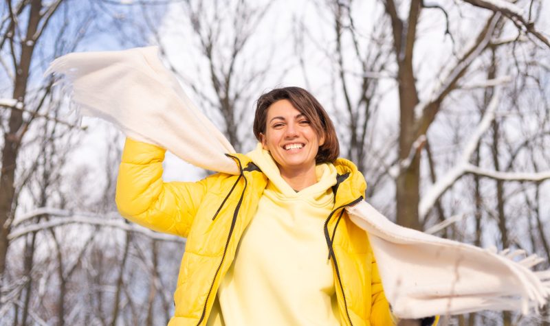 Beautiful young cheerful woman in a snowy landscape winter forest having fun rejoices in winter and snow in warm clothes, scarf Beautiful young cheerful woman in a snowy landscape winter forest having fun rejoices in winter and snow in warm clothes, scarf