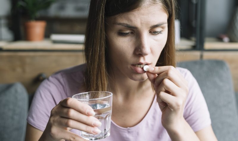 close-up-sick-young-woman-taking-medicine close-up-sick-young-woman-taking-medicine