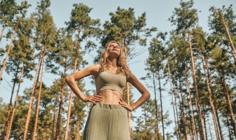 A woman practising yoga in the park and looking involved Morning yoga. A woman practising yoga in the park and looking involved